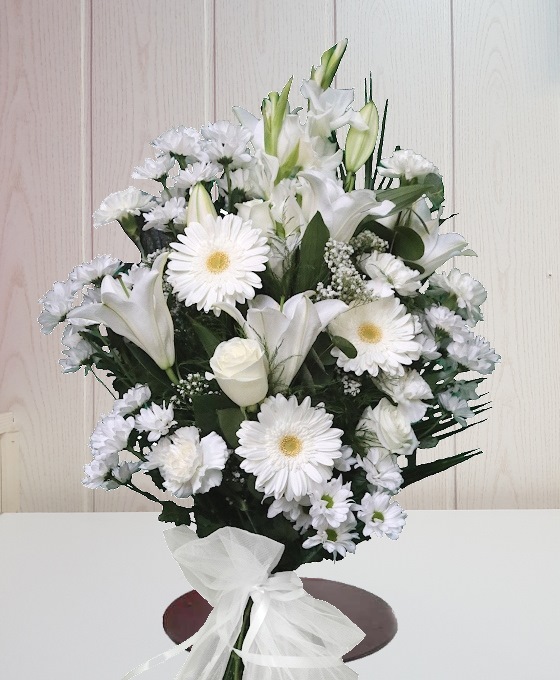 Ramo para funeral con flores como gerberas, liliums, rosas y margaritas blancas